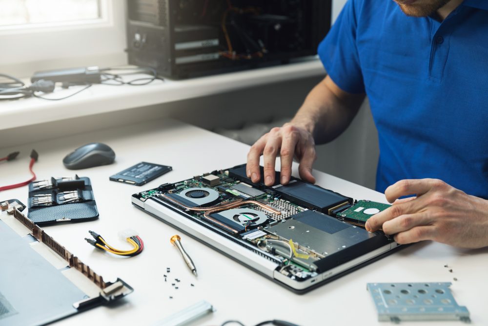 Technician repairing a laptop
